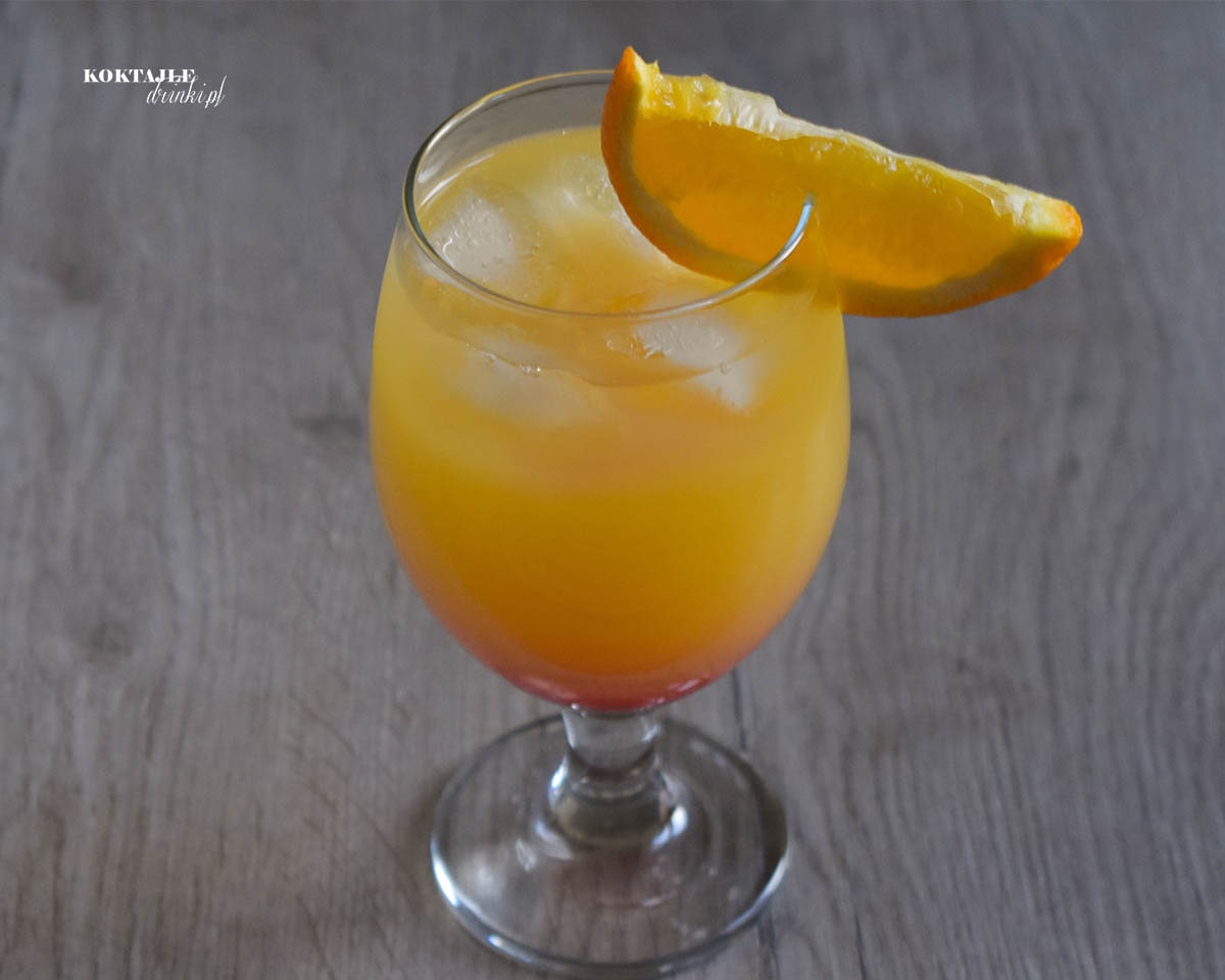 Ujęcie drugie na dwu warstwowy drink Gin Summer Night tym razem z góry ze zbliżeniem na plasterek pomarańczy jako ozdoba.