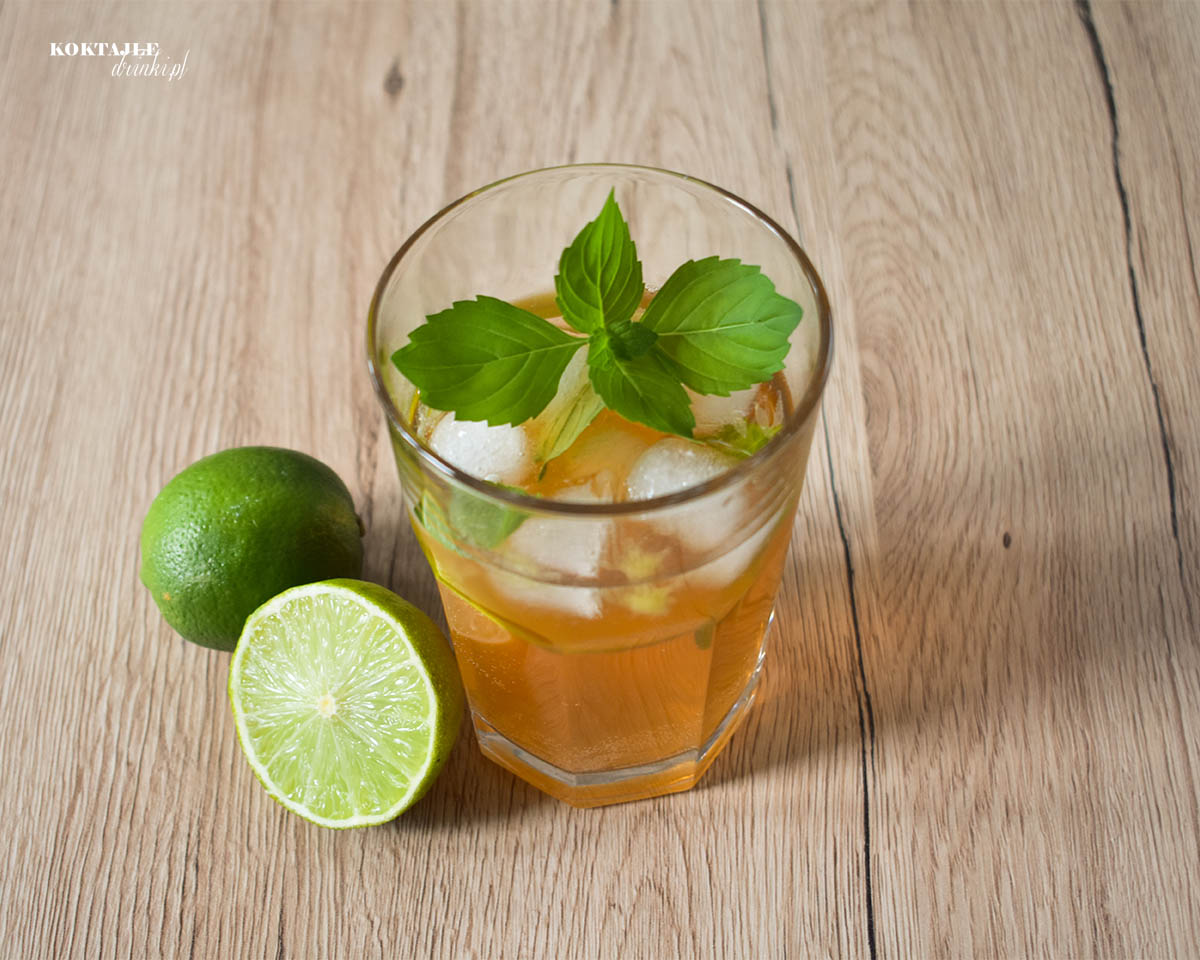 Widok z góry na drink z aperolem, Tropical Aperol, zbliżenie na liść mięty unoszący się na szklance.